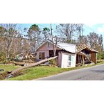 Trees, debris tangle home at roadside, S. Hancock Co., MS