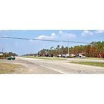Trucks await orders along US-90 west of Waveland, MS.